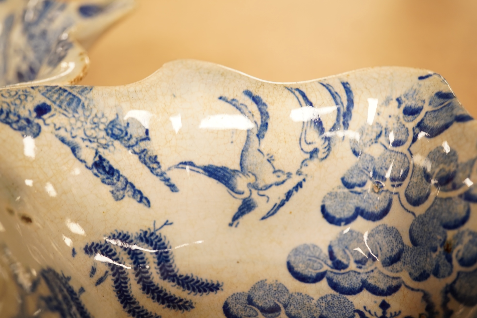 Two late 18th century Worcester or Caughley Cormorant fisherman pattern leaf pickle dishes and two early 19th century blue and white pottery leaf pickle dishes, largest 14.5cm long.